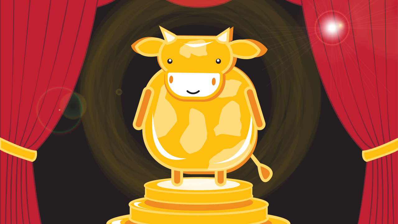 illustrated cow statue in front of red theatre curtains