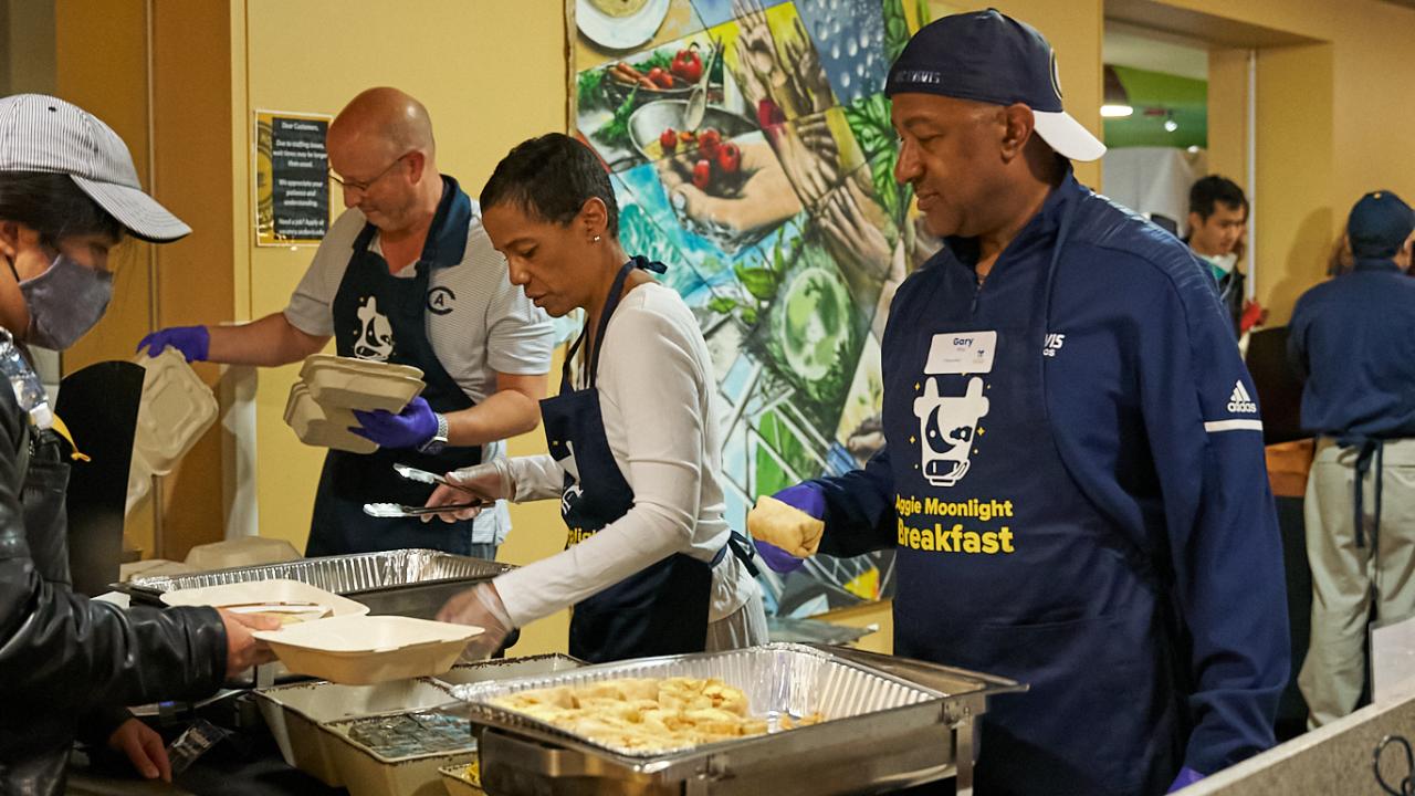 Chancellor Gary S. May, wife LeShelle R. May, and campus leadership serve food to students