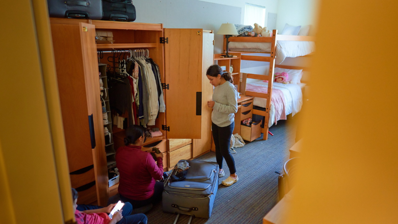 Resident packing up their clothes in their room