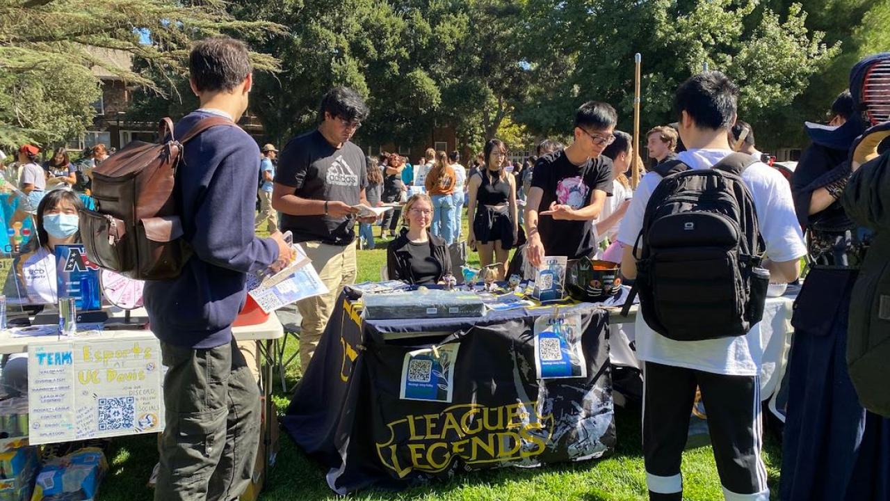 Students and club members learn about getting involved in on-campus registered organizations during the involvement fair on the quad. Students are sharing resources, club information, and sign-up links for recruitment. 